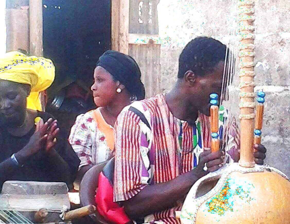 Musicians performing in Senegal — kora player and singers